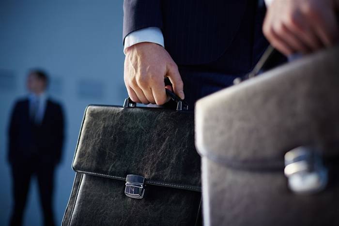 Hand holding a leather briefcase